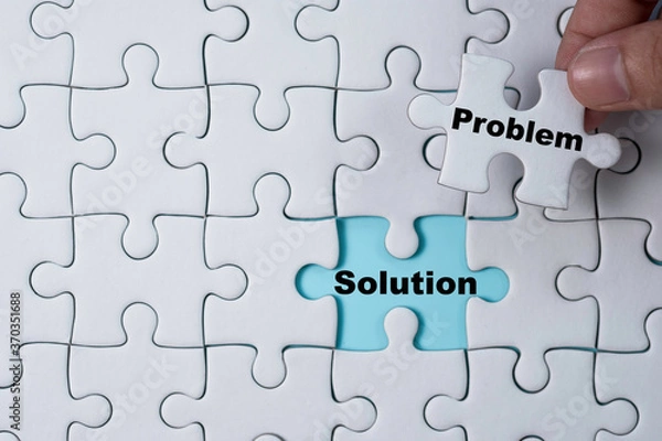 Obraz Hand holding and putting problem jigsaw puzzle to solution. Problem solving concept.