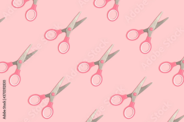 Fototapeta Scissors pattern on a pink pastel background. Monochrome composition.