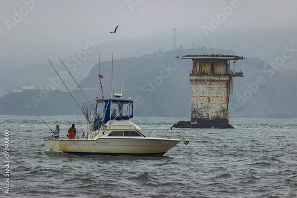 Fototapeta Fishing oat near Miles Rocks Lighthouse, San Francisco