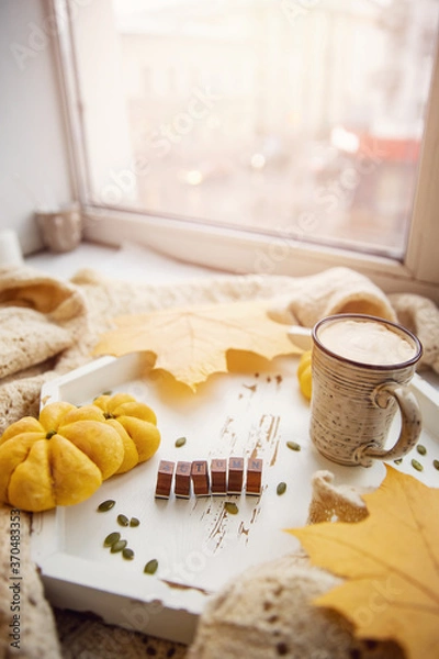 Fototapeta Autumn mood, top view cup of hot coffee stands next to window sun light yellow maple leaf