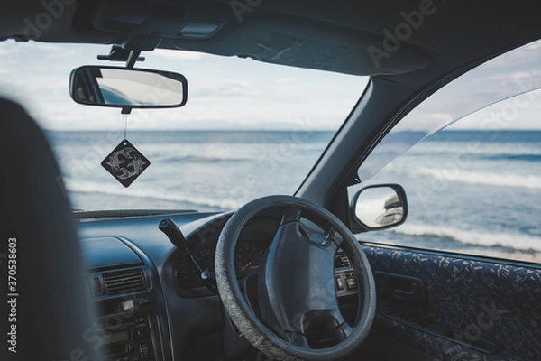 Fototapeta view of the ocean with large waves from the dark interior of the car