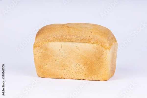 Fototapeta a loaf of fresh wheat bread on a white background
