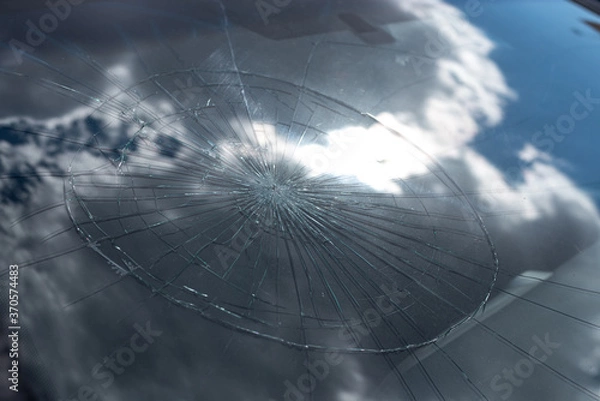 Fototapeta 
Broken glass after crash or impact in blue sky reflection