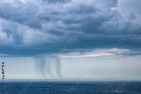 Obraz Small rain over the sea from a dark cloud