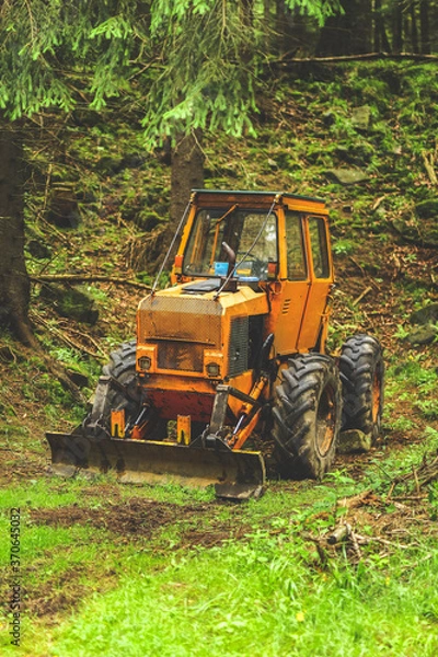 Fototapeta old tractor in the forest