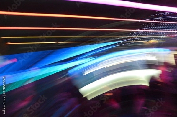 Fototapeta Long exposure photo of color LED and Neon lights with camera motion and dark background