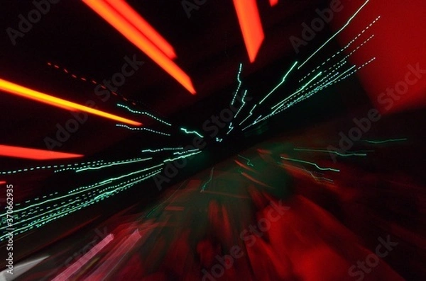 Obraz Long exposure photo of color LED and Neon lights with camera motion and dark background