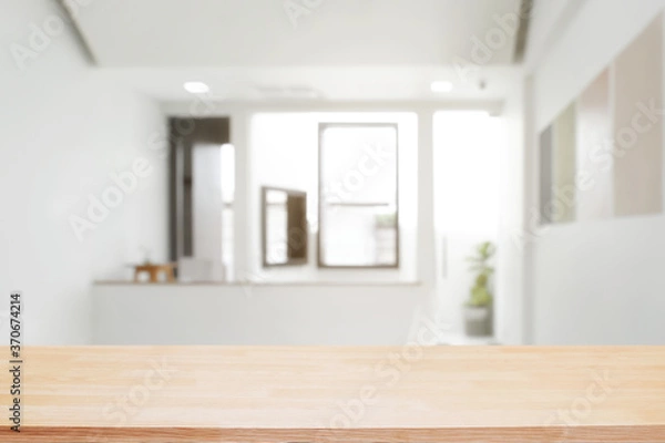Fototapeta Empty wooden desk space and blurry background of home window for product display montage.