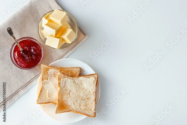 Obraz Toasted bread, strawberry marmalade and butter. Top view