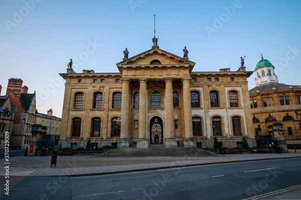 Obraz The Clarendon Building from Broad Street in Oxford with no people. Early in the morning with the Sheldonian Theatre beside it. Oxford, England, UK.