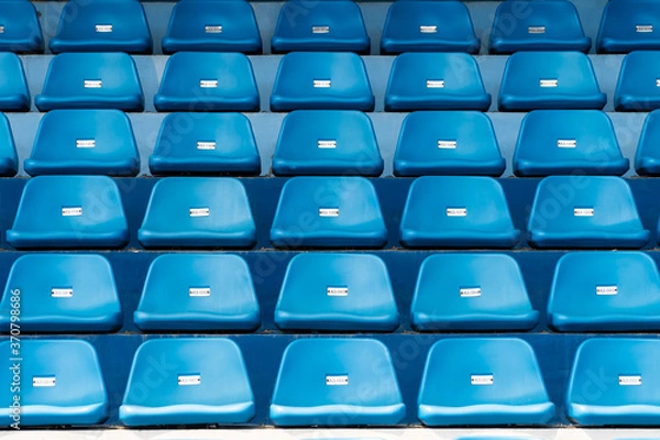 Fototapeta Blue stadium seats with number. Empty plastic chairs in stadium.