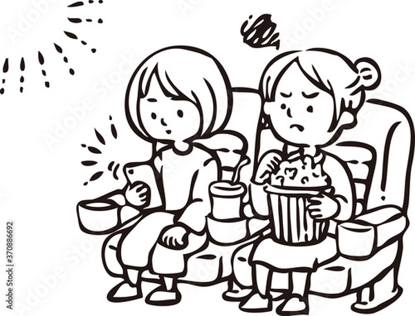 Fototapeta 映画上映中にスマートフォンを見る女性