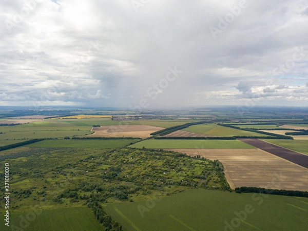 Fototapeta Aerial drone view. Rain clouds over the Ukrainian field. It is raining.