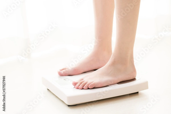 Fototapeta 体重計に乗る女性の足元