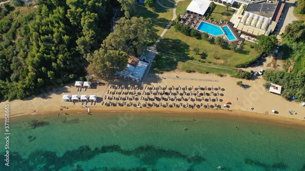 Fototapeta Aerial drone photo of famous organised with sun beds and umbrellas sandy beach of Agia Paraskevi in island of Skiathos, Sporades, Greece