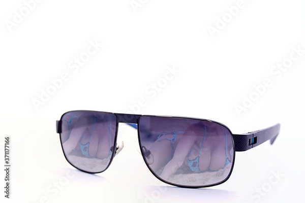 Fototapeta Sunglasses with reflection of a beautiful girl on the beach isolated on white background
