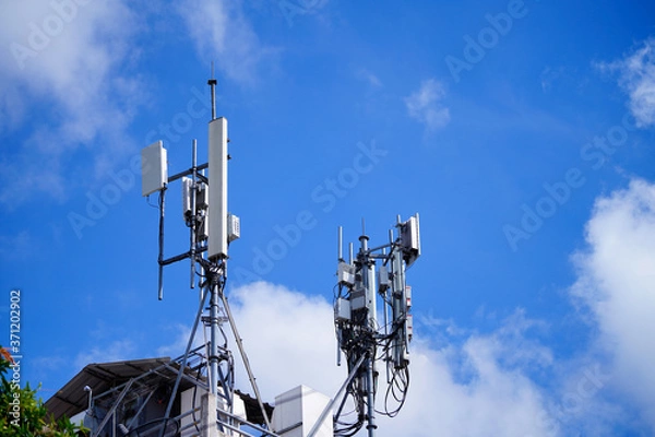 Fototapeta Telecommunication pole of 4G and 5G cellular. Base Station or Base Transceiver Station. 5G radio network telecommunication equipment with radio modules and smart antennas mounted on a metal.  