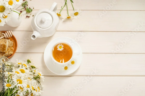 Fototapeta Chamomile and honey tea with copy space on white background