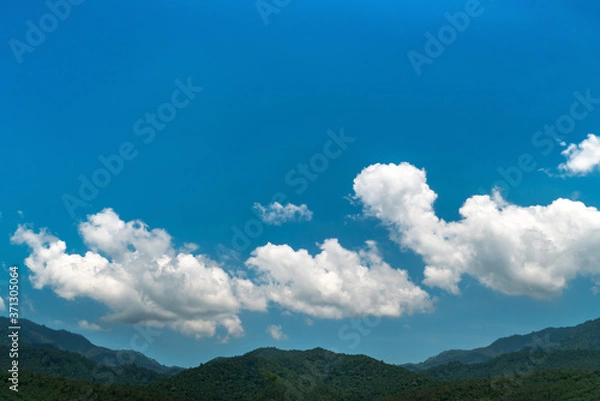 Fototapeta Blue sky background with clouds over the mountain