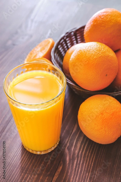Obraz Glass of fresh orange juice on table