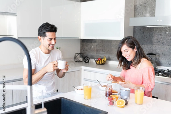 Fototapeta Happy Couple Having Breakfast In Kitchen