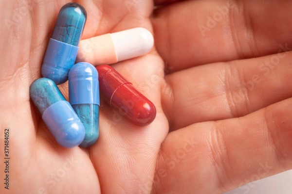 Obraz hand with five colored pills closeup