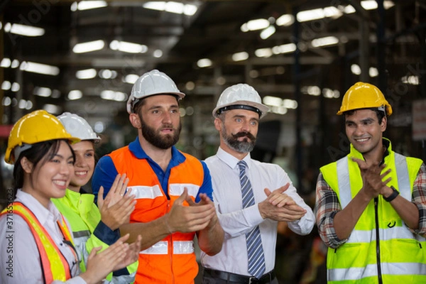 Fototapeta Group of Engineer manager and Factory Workers Team standing against production line.