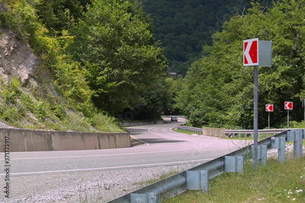 Fototapeta Curved asphalt road in high mountains. summer day