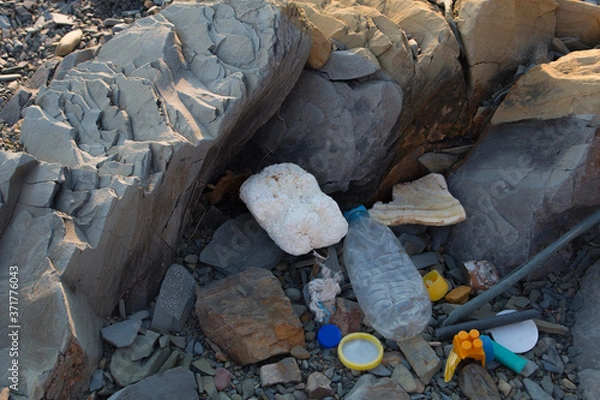 Obraz Spilled garbage on the beach. Empty used dirty plastic bottles. Dirty sea sandy shore the Black Sea. Environmental pollution. Ecological problem.