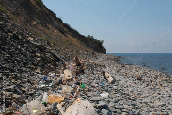 Obraz Spilled garbage on the beach. Empty used dirty plastic bottles. Dirty sea sandy shore the Black Sea. Environmental pollution. Ecological problem.