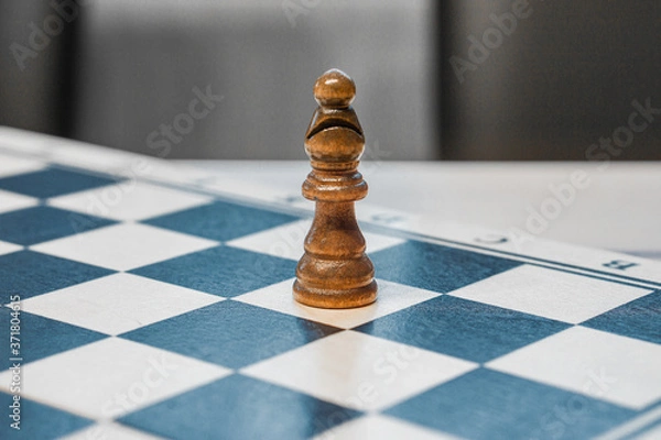 Fototapeta chessman bishop on a chessboard