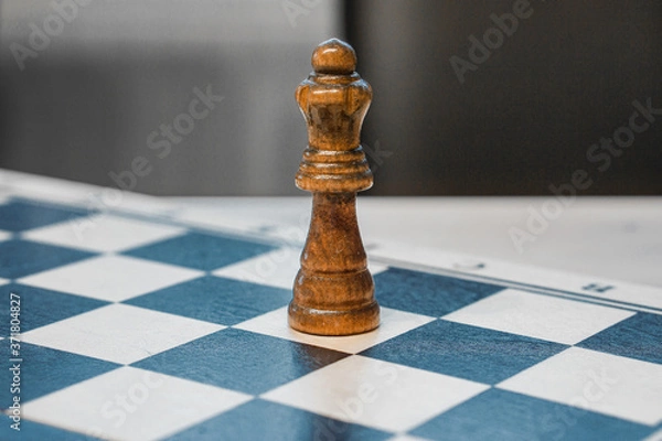 Fototapeta chessman queen on a chessboard