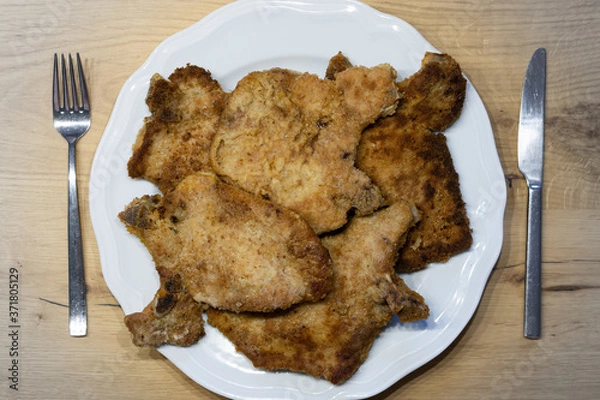 Fototapeta breaded chops or cutlets on a white plate