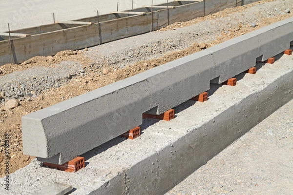 Obraz Concrete curb at road construction site.