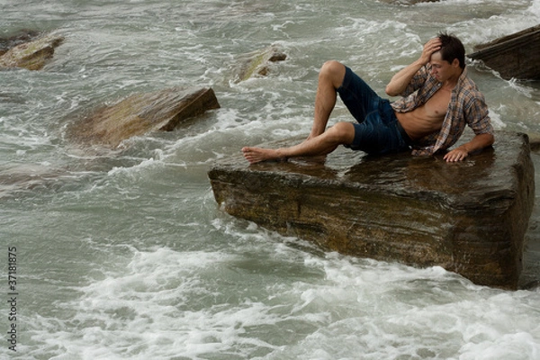 Obraz brawny lad on stone at sea