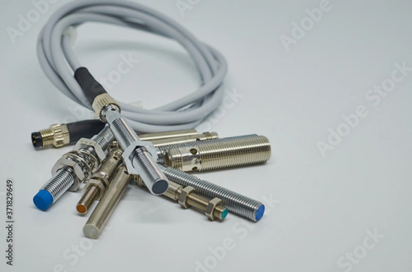 Obraz Many Inductive proximity sensor or proximity switch on a white background.