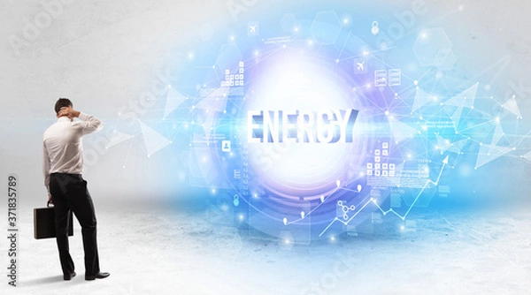 Fototapeta Rear view of a businessman standing in front of ENERGY inscription, modern technology concept