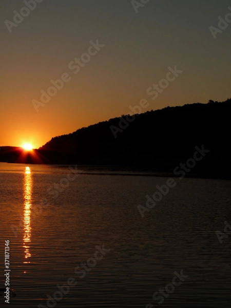 Fototapeta sunset on the lake with sunlights