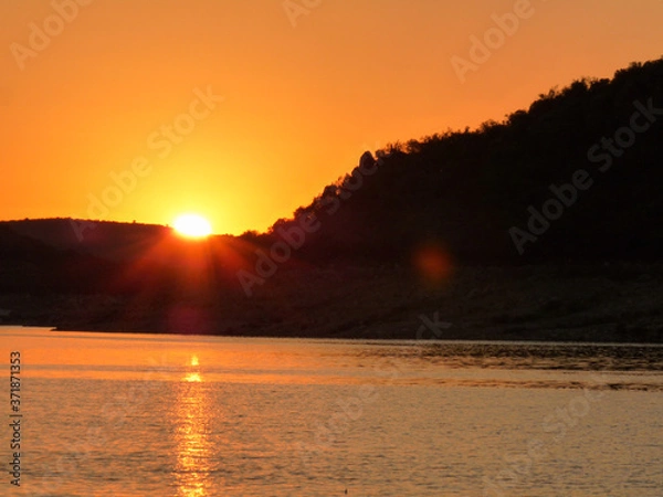 Fototapeta sunset in the river with mountains