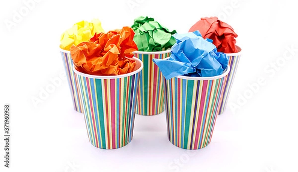 Fototapeta Colored wrinkled paper and paper cup, close up on white background