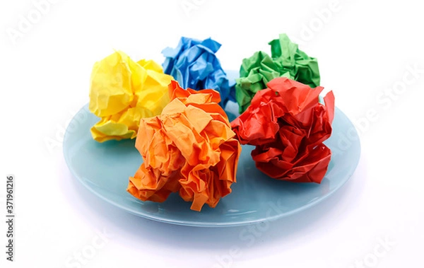 Fototapeta Colored wrinkled paper on a plate, close up on a white background