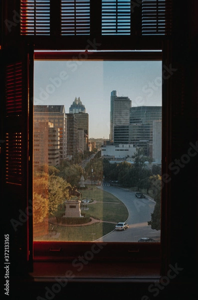 Fototapeta A unique view of a city through a window