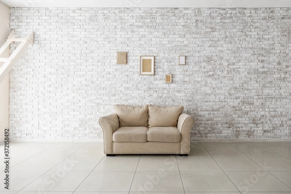 Fototapeta Comfortable sofa in empty room