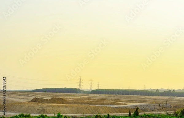 Fototapeta Electricity pole with silhouette sunset sky, Electricity pylon with shadow of tree in dawn time, Electricity power transmission line on sunset with copy space, Electricity pylon on orange sky