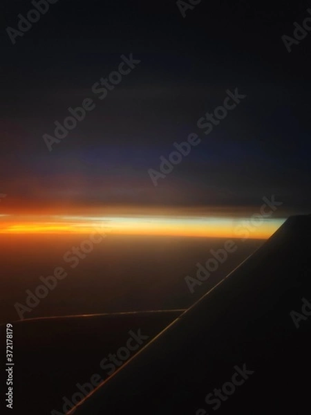 Fototapeta sunset over the clouds