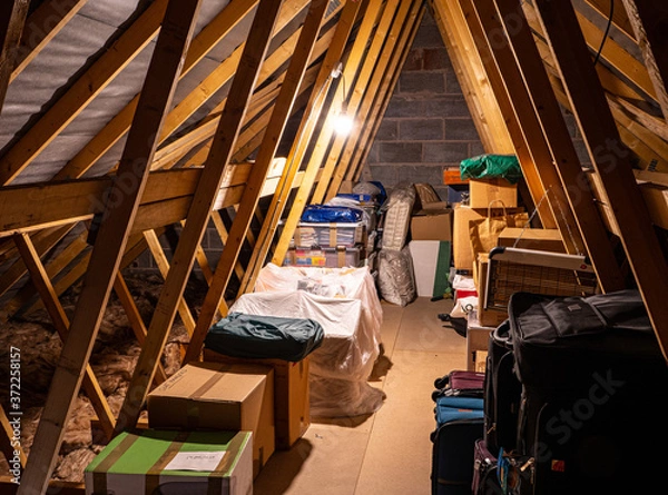 Fototapeta Loftspace in the attic roof of a family home, is a favourite storage place for cases, boxes and personal treasures.