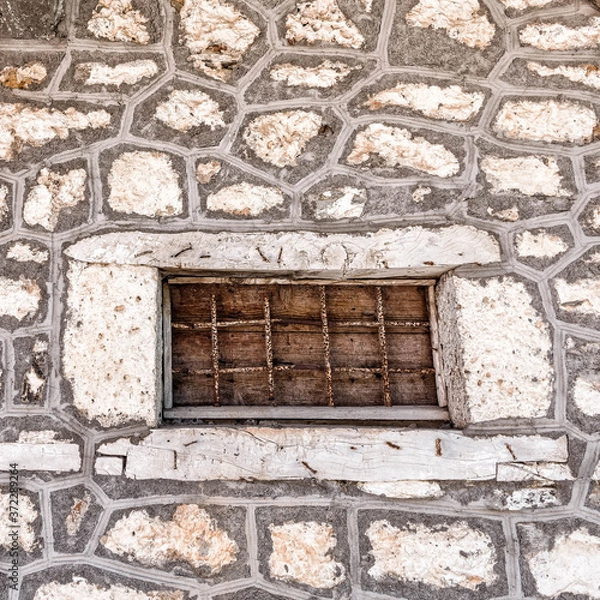 Obraz grunge iron railings secured window frame and stone wall, space for text