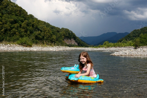 Obraz happy laughing girl enjoying swimming in river with rubber ring crocodile. active summer vacation on the beach