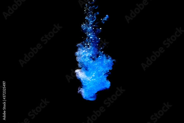 Fototapeta A cloud of blue paint released into clear water. Isolate on a black background.