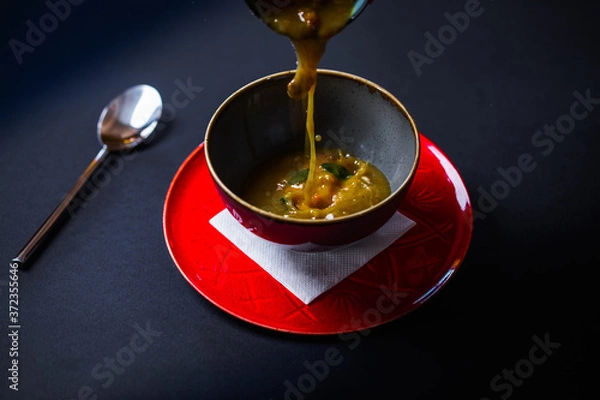 Fototapeta Bowel of beef broth soup in rustic clay bowel